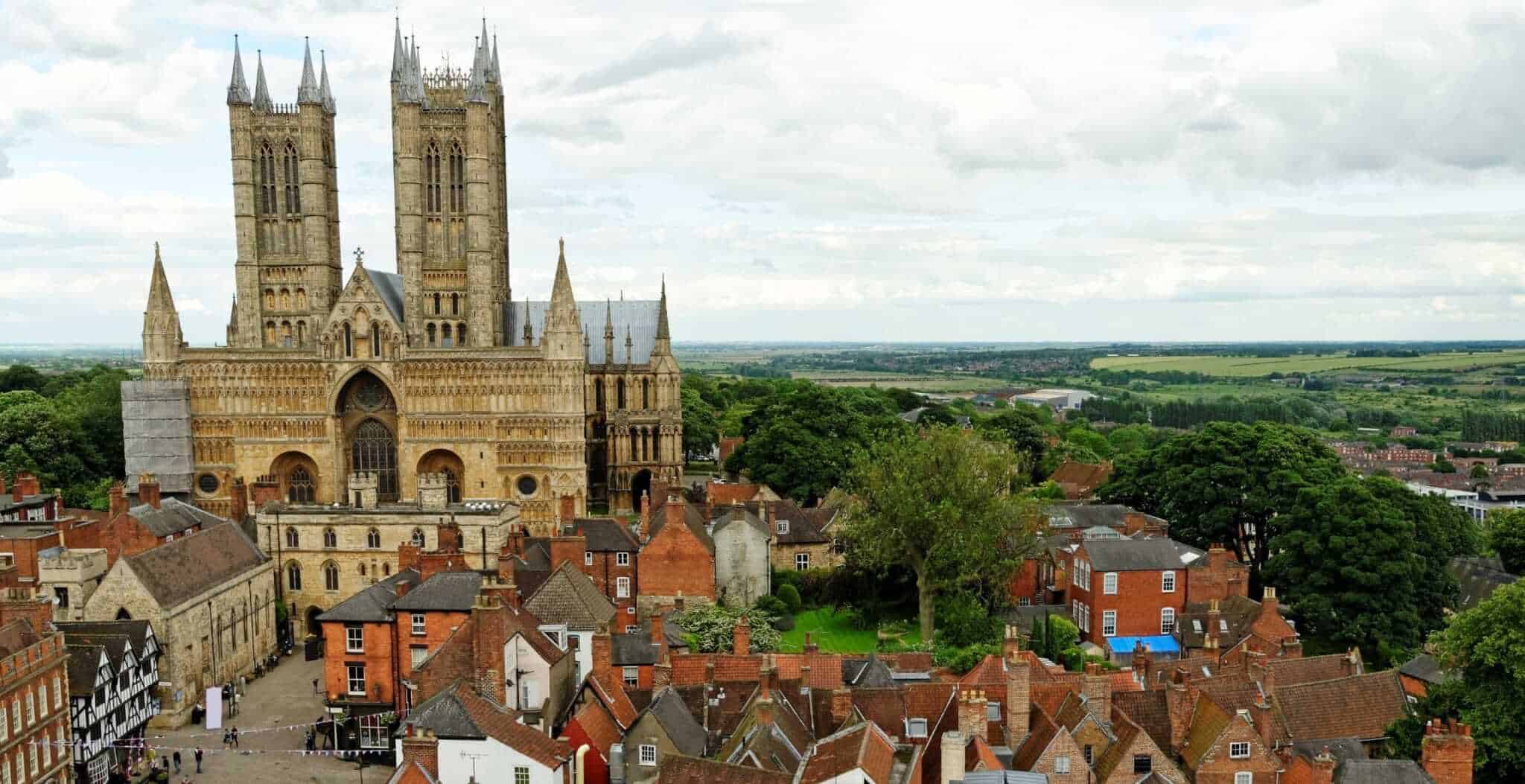 Arial photo of Lincoln Cathedral with green countryside in the distance.